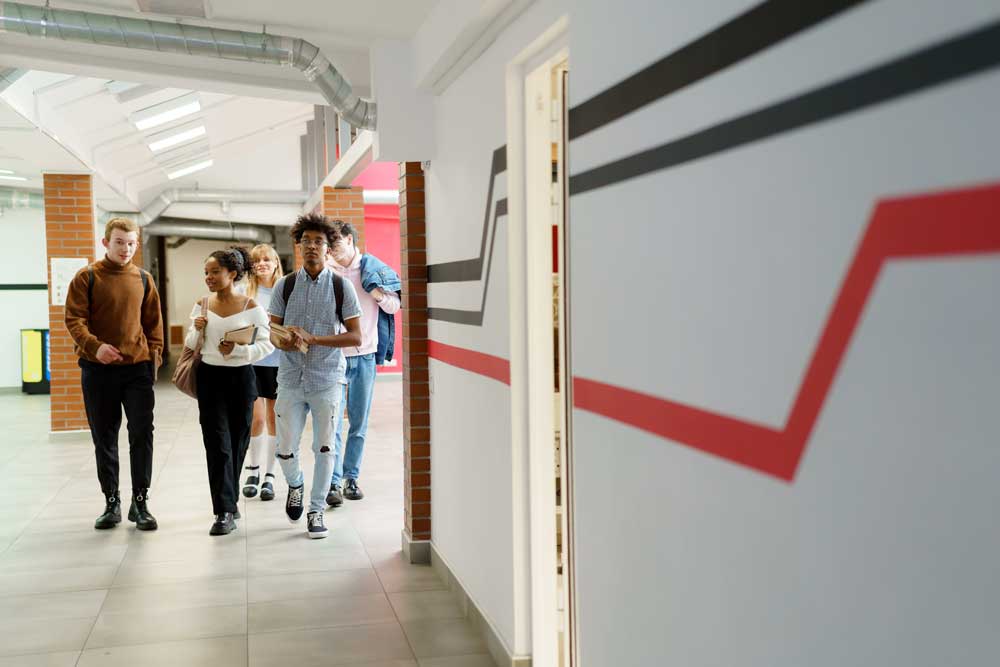 students walking down a hall at a school